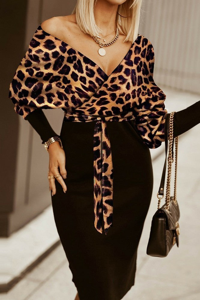 Elegant black midi dress with leopard print wrap neckline and long sleeves, featuring a fitted skirt and included belt.