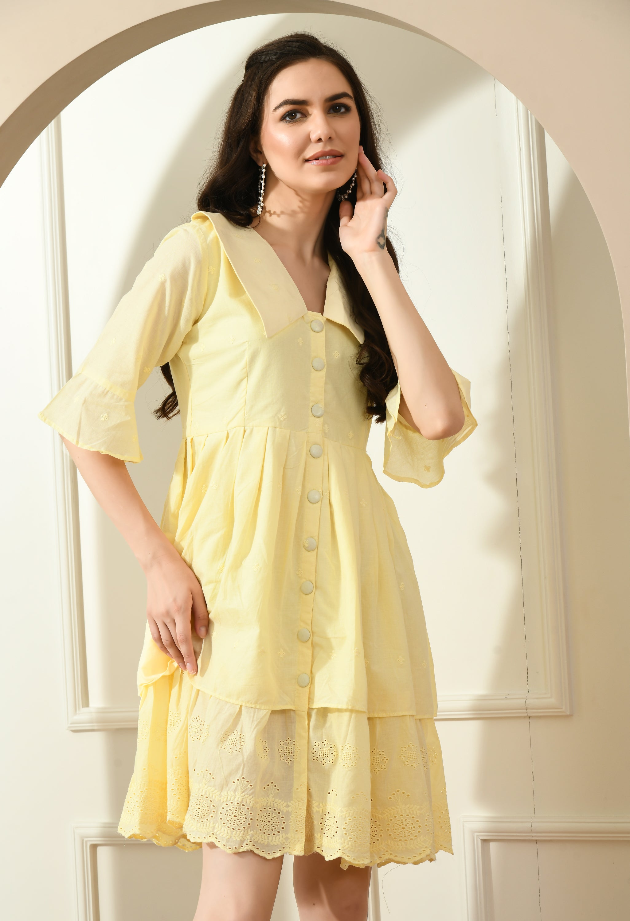 A stylish yellow Hakoba dress featuring big collars, wood buttons, and an A-line fit, perfect for casual occasions.