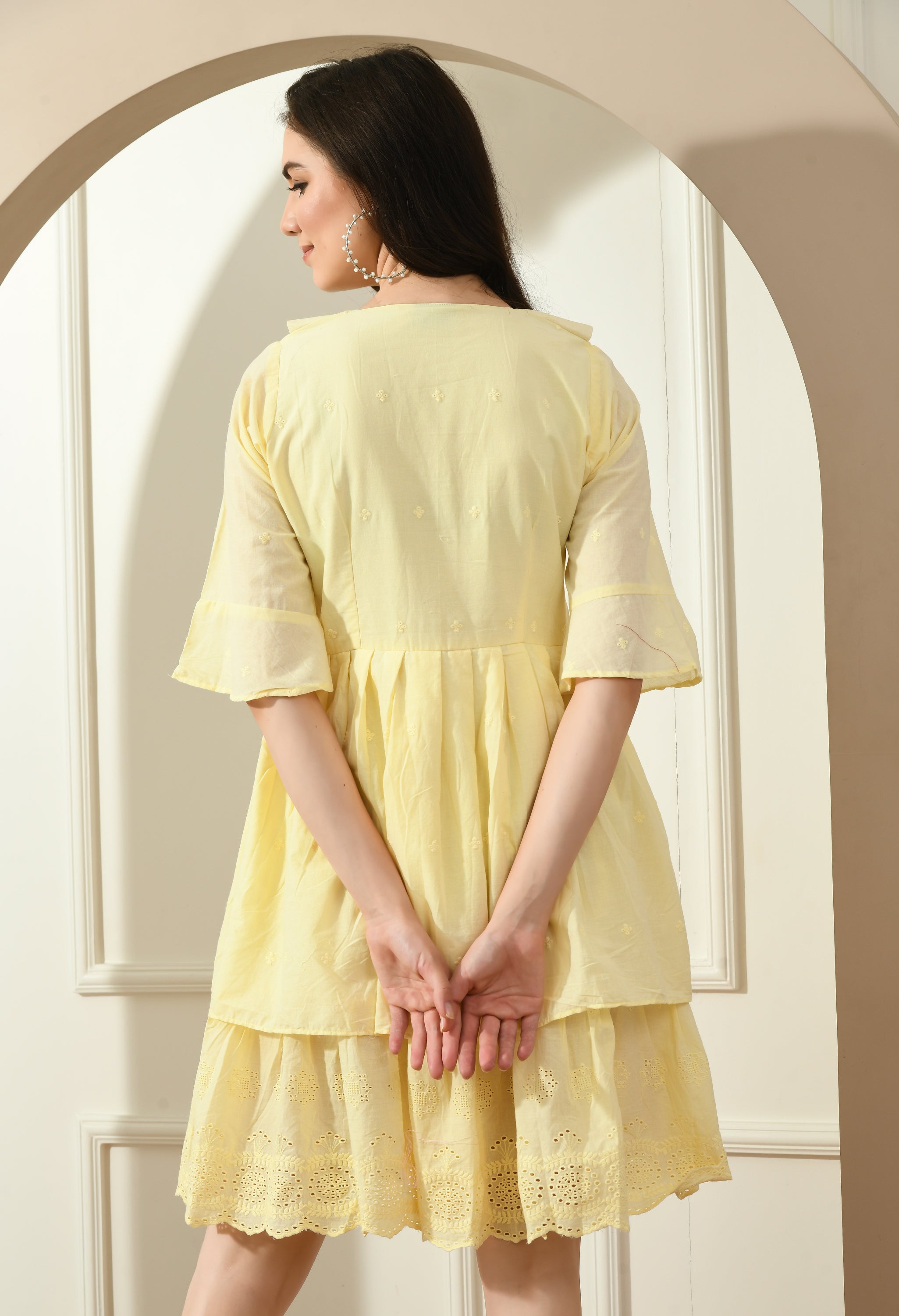 A stylish yellow Hakoba dress featuring big collars, wood buttons, and an A-line fit, perfect for casual occasions.