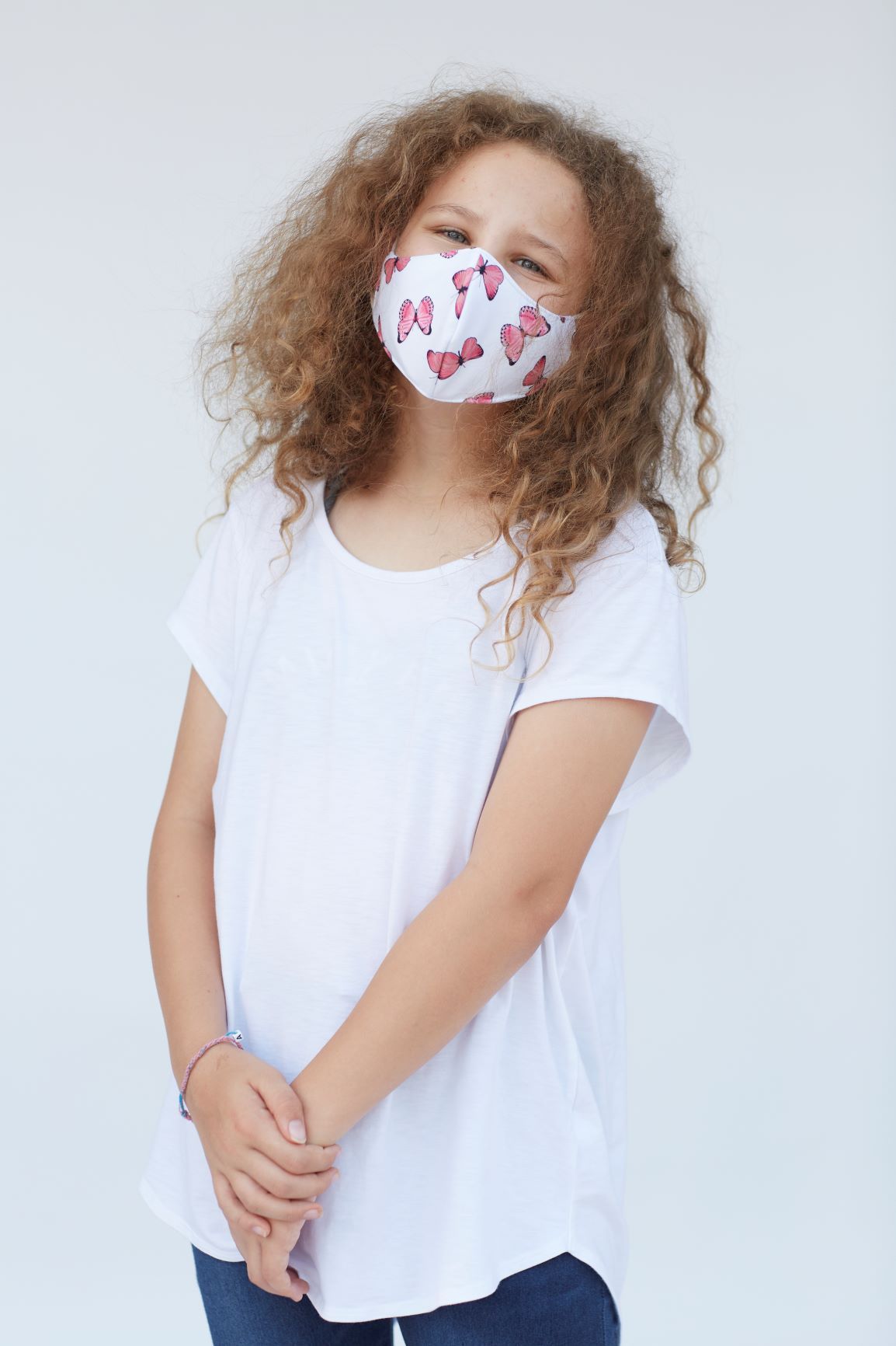 Youth Pink Butterfly Face Mask featuring a vibrant butterfly design, made of 3 layers for comfort and breathability.