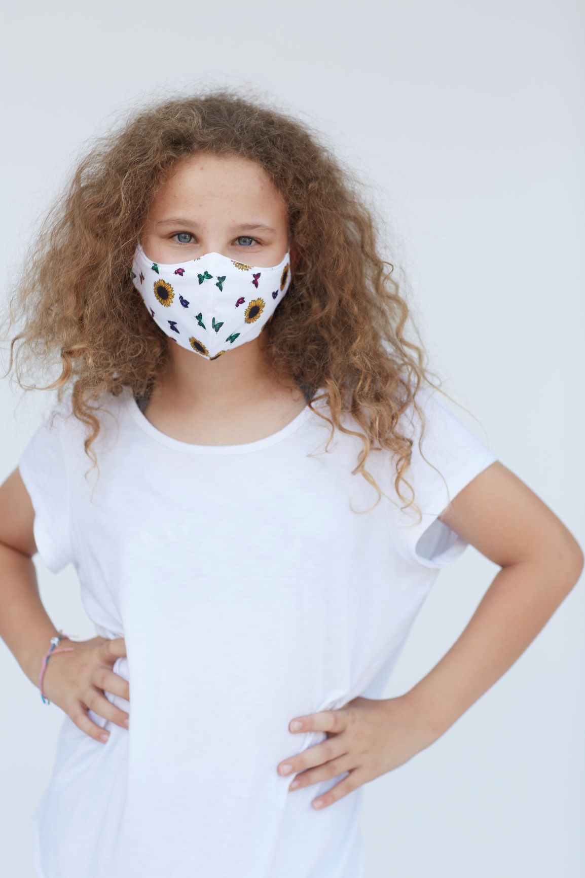 Youth Sunflower Butterfly Face Mask featuring a vibrant sunflower and butterfly design, made of breathable cotton and polyester layers.