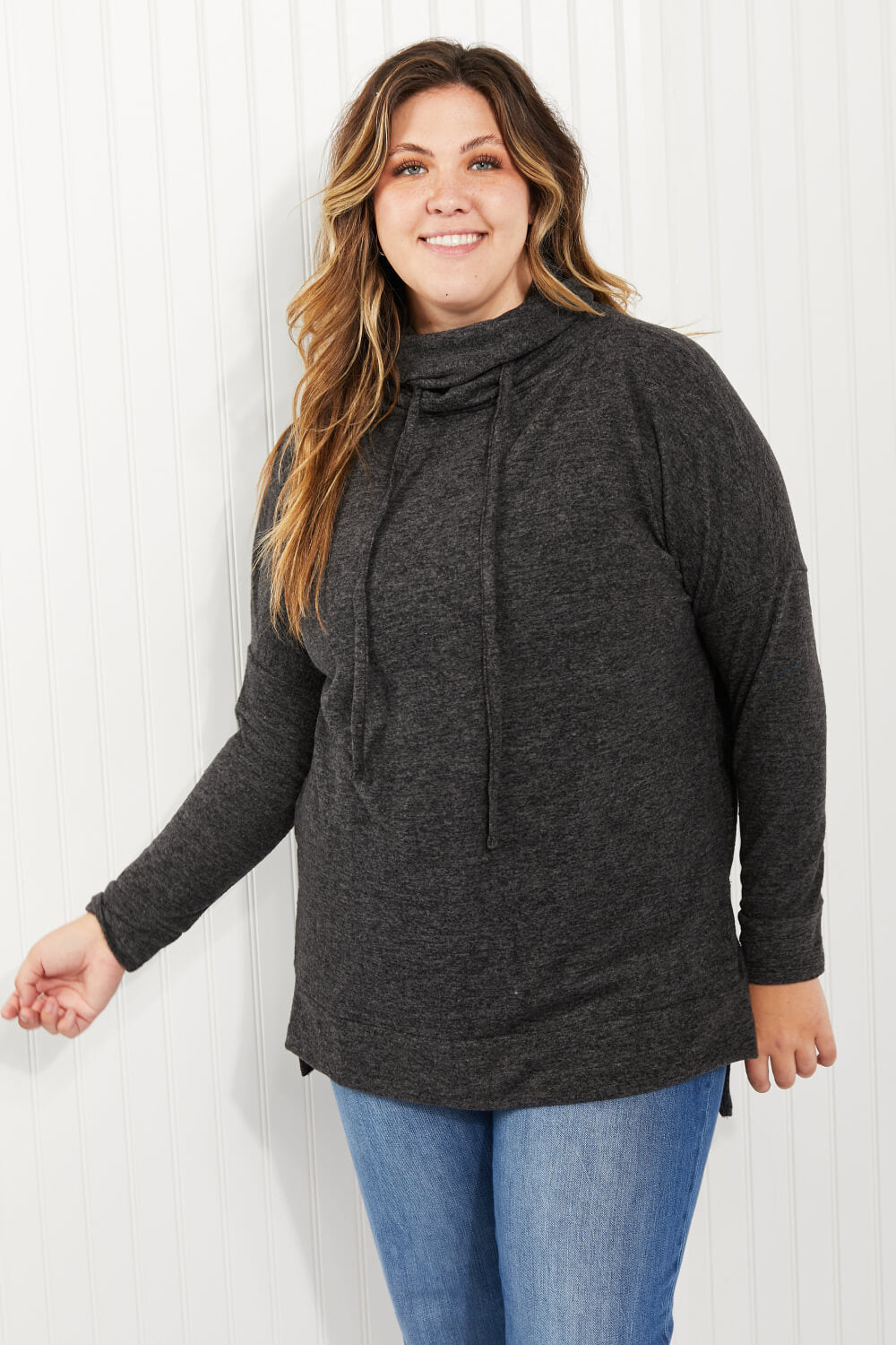 Zenana Full Size Brushed Funnel Neck Sweater in a studio setting, showcasing its funnel neck design and long sleeves.