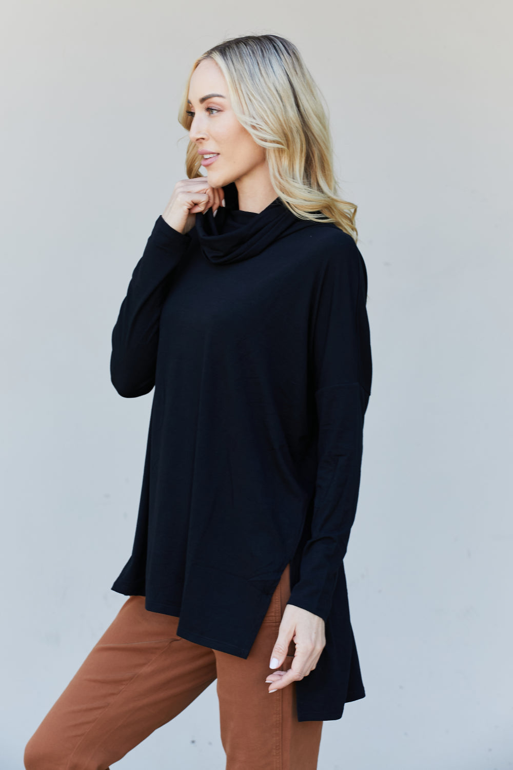 Zenana Full Size Slit High-Low Funnel Neck Top in Black, featuring a stylish slit design and cozy funnel neck, perfect for casual wear.