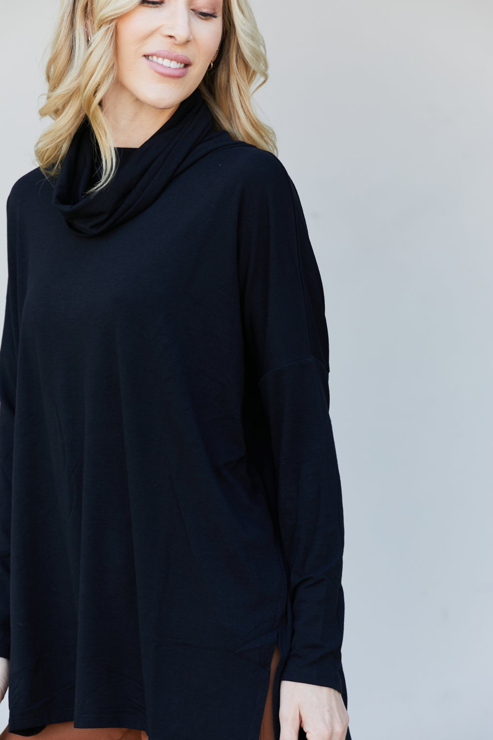 Zenana Full Size Slit High-Low Funnel Neck Top in Black, featuring a stylish slit design and cozy funnel neck, perfect for casual wear.