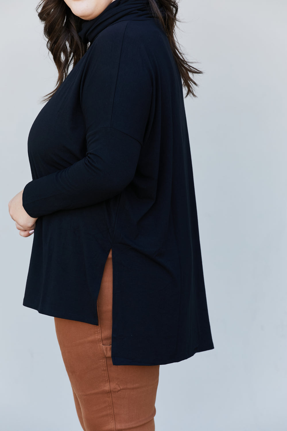Zenana Full Size Slit High-Low Funnel Neck Top in Black, featuring a stylish slit design and cozy funnel neck, perfect for casual wear.
