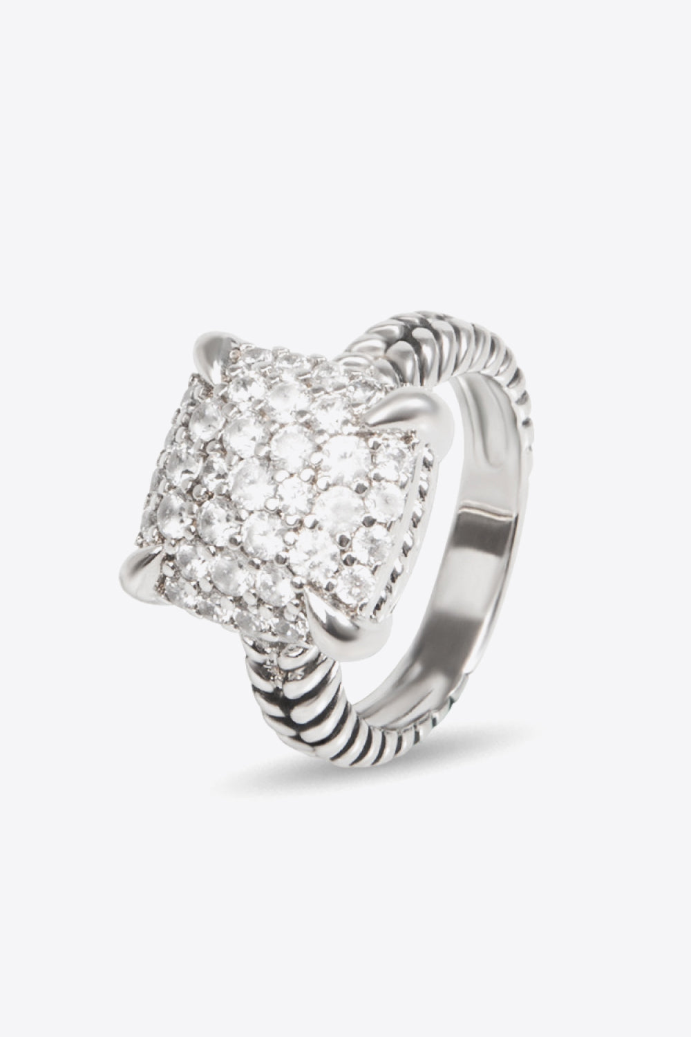 Zircon Twisted Ring featuring a minimalist design, crafted from zircon and copper with an 18k platinum-plated finish, displayed in a flat lay style.