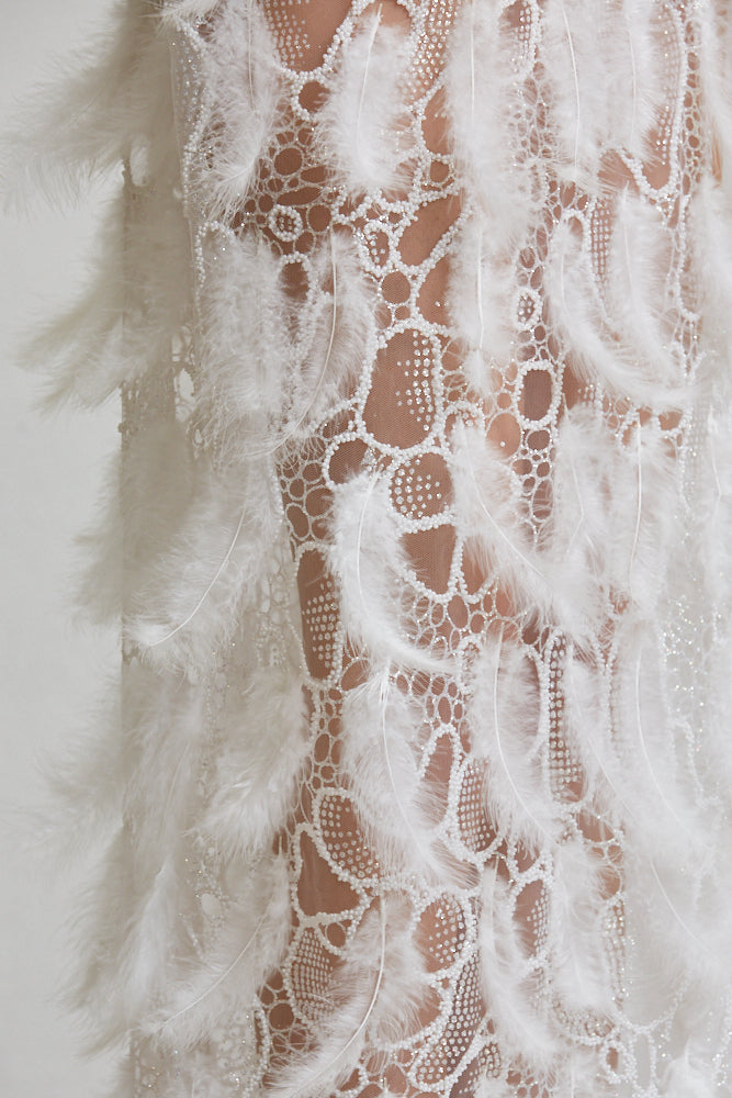 The Zoey Dress showcasing luxurious satin fabric, intricate bead detailing, and a thigh-high slit, perfect for special occasions.